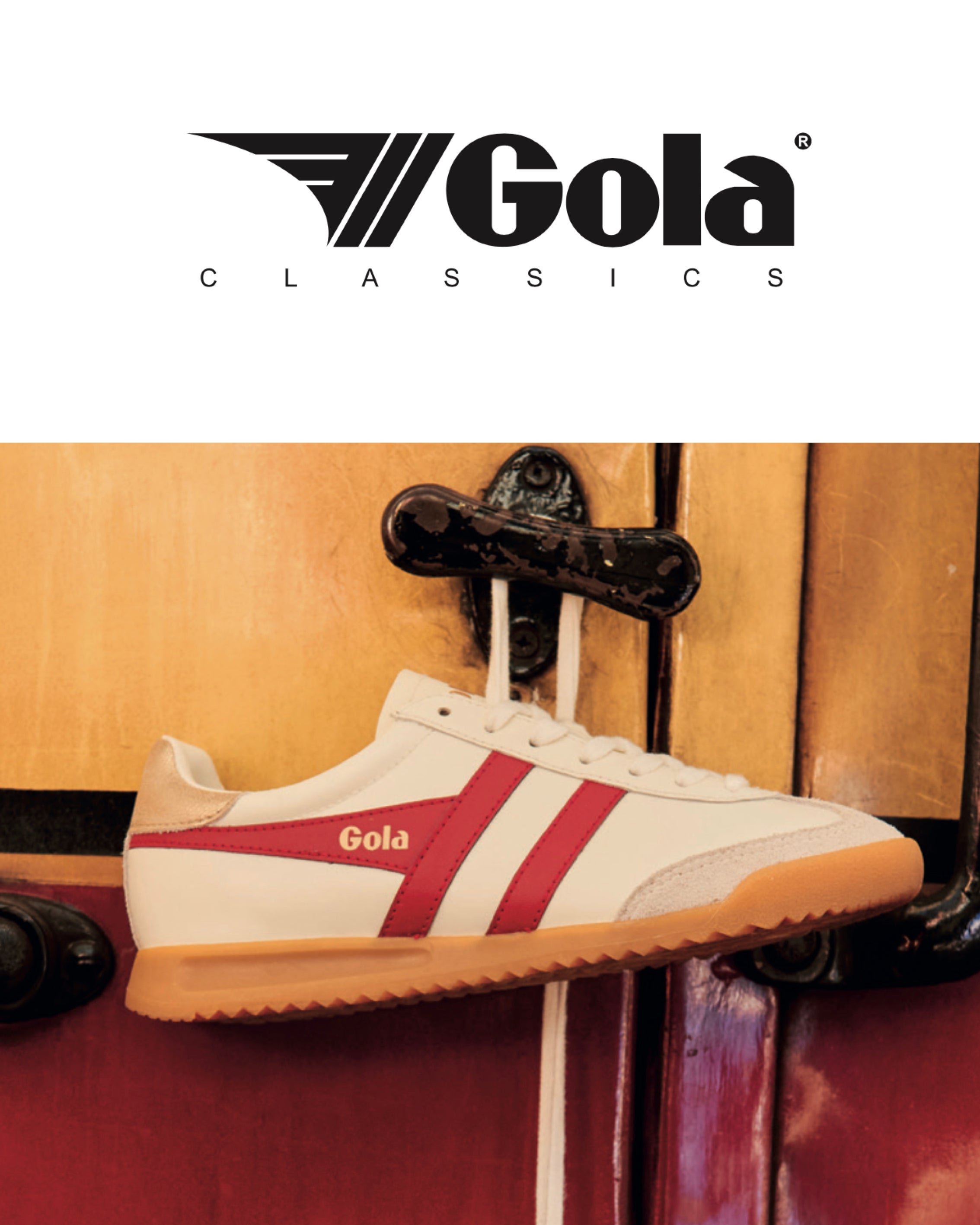 White Gola sneaker with red stripe hanging on a suitcase handle.
